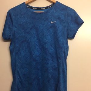 blue nike running shirt.